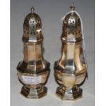 A NEAR PAIR OF BIRMINGHAM SILVER OCTAGONAL SHAPED SUGAR CASTERS, 7.8 TROY OZS.