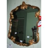 A PAIR OF 20TH CENTURY GILT COMPOSITE WALL MIRRORS, OF CUSHION FORM WITH ROCOCO STYLE C-SCROLL AND