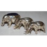 AN EARLY 20TH CENTURY NOVELTY WHITE METAL PIN CUSHION IN THE FORM OF AN ELEPHANT WITH HANGING