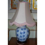 A DECORATIVE BLUE AND WHITE PORCELAIN JAR AND COVER CONVERTED TO A TABLE LAMP AND SHADE