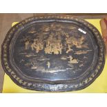 A 19TH CENTURY CHINESE EXPORT BLACK AND GILT LACQUER TRAY OF OVAL FORM DECORATED WITH PAVILLIONS AND