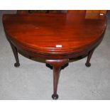 A GEORGE II AND LATER MAHOGANY DOUBLE FOLD-OVER DEMILUNE COMBINATION TEA AND GAMES TABLE, WITH PLAIN