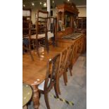 A VICTORIAN OAK DINING ROOM SUITE COMPRISING MIRROR BACK SIDEBOARD, EXTENDING DINING TABLE WITH