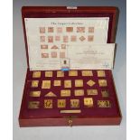 A CASED SET OF TWENTY FIVE SILVER GILT COMMEMORATIVE STAMPS, THE EMPIRE COLLECTION LIMITED