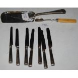 A LONDON SILVER CRUMB SCOOP, A SILVER STILTON SCOOP AND EIGHT SILVER HANDLED TABLE KNIVES. Buyer's