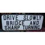 EARLY 20TH CENTURY CAST METAL SIGN 'DRIVE SLOWLY BRIDGE AND SHARP TURNING' WITH BLACK AND WHITE