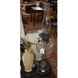 A LATE 19TH CENTURY PARAFIN BURNING OIL LAMP WITH CLEAR GLASS RESERVOIR TOGETHER WITH A COMPOSITE