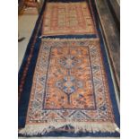 A PERSIAN RUG, 20TH CENTURY, THE ORANGE GROUND CENTRED WITH TWO BLUE GROUND LOZENGE SHAPED