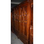 EARLY 20TH CENTURY STAINED OAK WARDROBE FITTED WITH THREE DOORS OVER TWO LONG DRAWERS