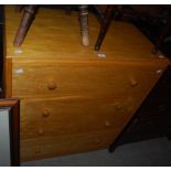 BLONDE WOOD CHEST OF FOUR LONG DRAWERS, THE UPPER DRAWER WITH HINGED FALL-FRONT