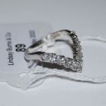 AN 18CT WHITE GOLD AND NINE STONE DIAMOND SET RING