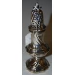 AN ANTIQUE WHITE METAL SUGAR SHAKER, MAKERS MARK P, WITH DETACHABLE PIERCED COVER AND PINEAPPLE
