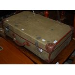 A VINTAGE GREEN CANVAS AND BROWN LEATHER TRIMMED SUITCASE.