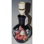 A MOORCROFT TABLE LAMP, THE BODY WITH FLORAL DESIGN ON A BLUE GROUND, IMPRESSED 'MOORCROFT' AND '