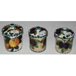 THREE WEMYSS WARE JARS AND COVERS, INCLUDING ONE DECORATED WITH DAMSONS, IMPRESSED AND GREEN PAINTED