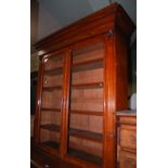 A 19TH CENTURY MAHOGANY BOOKCASE, THE UPPER SECTION WITH TWO GLAZED CUPBOARD DOORS OPENING TO A