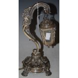 A LATE 19TH/EARLY 20TH CENTURY CONTINENTAL WHITE METAL TABLE LAMP IN THE FORM OF A SCROLL OVER