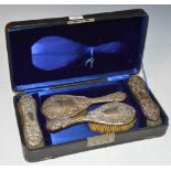 A CASED BIRMINGHAM SILVER FOUR PIECE DRESSING TABLE BRUSH SET