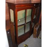 AN EDWARDIAN MAHOGANY AND BOXWOOD LINED BOWFRONT DISPLAY CABINET WITH TWO ASTRAGAL GLAZED DOORS (CUT