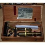 A VINTAGE MICROSCOPE IN MAHOGANY CASE BEARING NOTE 'MICROSCOPE BELONGED TO JAMES ROBERTSON JUSTICE'