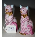 A PAIR OF HEREND PORCELAIN SEATED CATS WITH TYPICAL DECORATION IN PINK, BOTH WITH GILDED BOW TIE