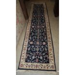 BLUE GROUND PERSIAN RUNNER, 20TH CENTURY DECORATED WITH SCROLLING FLOWERS AND FOLIAGE WITHIN A WHITE