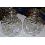 A PAIR OF LONDON SILVER MOUNTED CLEAR GLASS TOILET BOTTLES AND STOPPERS