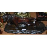 A LATE 19TH/EARLY 20TH CENTURY JAPANESE BRONZE MODEL OF A TIGER ON CARVED WOODEN PLINTH, 43CM LONG