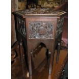 AN EARLY 20TH CENTURY HEXAGONAL SHAPED STAINED WOOD OCCASIONAL TABLE, THE TOP CARVED IN RELIEF