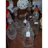 SIX CUT GLASS DECANTERS INCLUDING A SILVER-PLATED MOUNTED CLARET JUG WITH STAR ENGRAVED