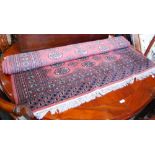 A 20TH CENTURY TEKKE STYLE PERSIAN RUG, WITH PINK FIELD AND LIGHT BLUE ORANGE AND CREAM BORDERS,