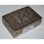 AN INDIAN WHITE METAL RECTANGULAR BOX, THE COVER EMBOSSED WITH FIGURES, THE SIDES OF ANIMALS, 5.2