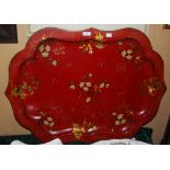 A LATE 19TH / EARLY 20TH CENTURY RED GROUND TOLE WARE TRAY, DECORATED WITH SCATTERED FOLIATE SPRAYS,