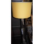 AN EARLY 20TH CENTURY WHITE METAL RISE AND FALL STANDARD LAMP WITH YELLOW COLOURED SHADE ON HAMMERED