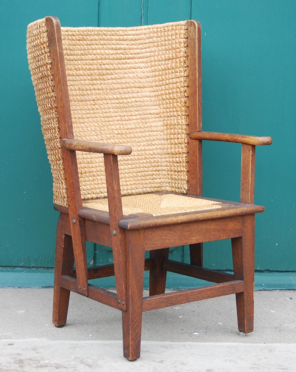 A late 19th / early 20th century childs Orkney chair, the arms with scroll carved detail, with