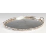 An antique Dutch silver oval tray, Amsterdam marks, with pierced scroll gallery and oval cut out