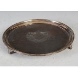 A George III silver salver, London 1791, makers mark of I.H, circular, engraved with armorial raised