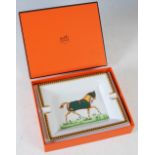 A Hermes, Paris porcelain ashtray in original fitted box, decorated with a horse wearing a green