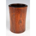 A Chinese dark wood brush pot, possibly Huanghuali, of slightly waisted cylindrical form, 11cm high