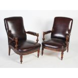 A pair of 20th century leather upholstered armchairs, with turned and facetted arm supports,