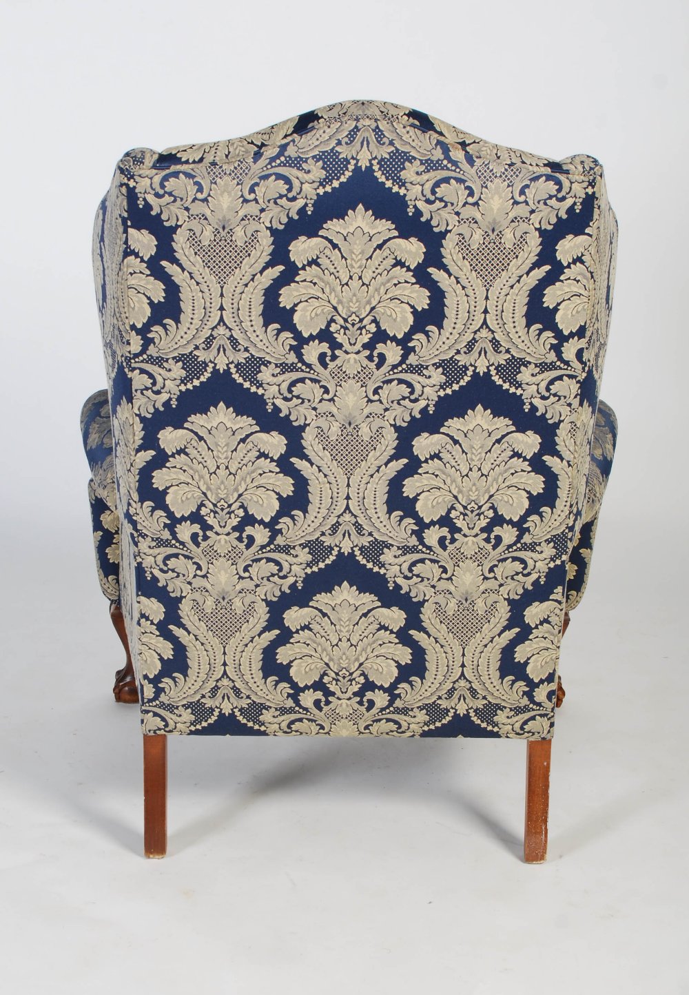 An early 20th century upholstered wingback armchair in the Georgian taste, the front carved oak legs - Image 6 of 6