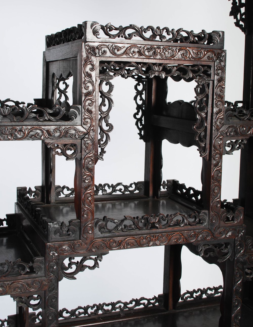 A Chinese carved darkwood display cabinet, Qing Dynasty, the arched top with a carved pediment - Image 5 of 11