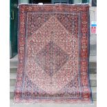 A Persian rug, late 19th / early 20th century, the rectangular field centred with a lozenge shaped