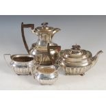 A George V four piece silver tea set, Sheffield, 1917, makers mark of Walker & Hall, oval shaped