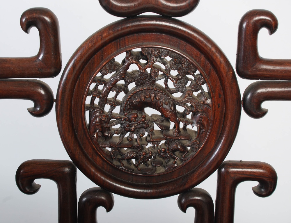 A Chinese carved darkwood armchair, late 19th/ early 20th century, the shaped back rail enclosing - Image 3 of 7