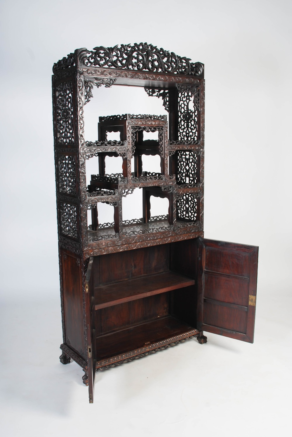 A Chinese carved darkwood display cabinet, Qing Dynasty, the arched top with a carved pediment - Image 7 of 11