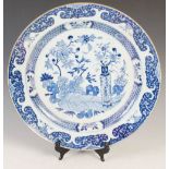 A Chinese porcelain blue and white charger, Qing Dynasty, decorated with vases issuing flowers