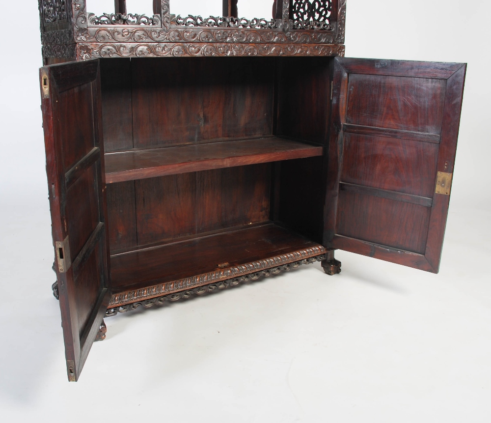 A Chinese carved darkwood display cabinet, Qing Dynasty, the arched top with a carved pediment - Image 8 of 11
