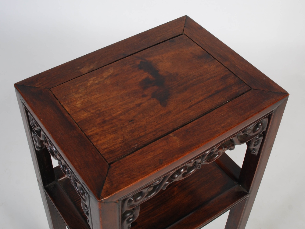 A Chinese darkwood urn stand, Qing Dynasty, the plain top with a carved scrolling frieze with - Image 2 of 6