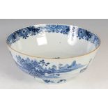 A Chinese porcelain blue and white punch bowl, Qing Dynasty, decorated with pavilions and sampans in